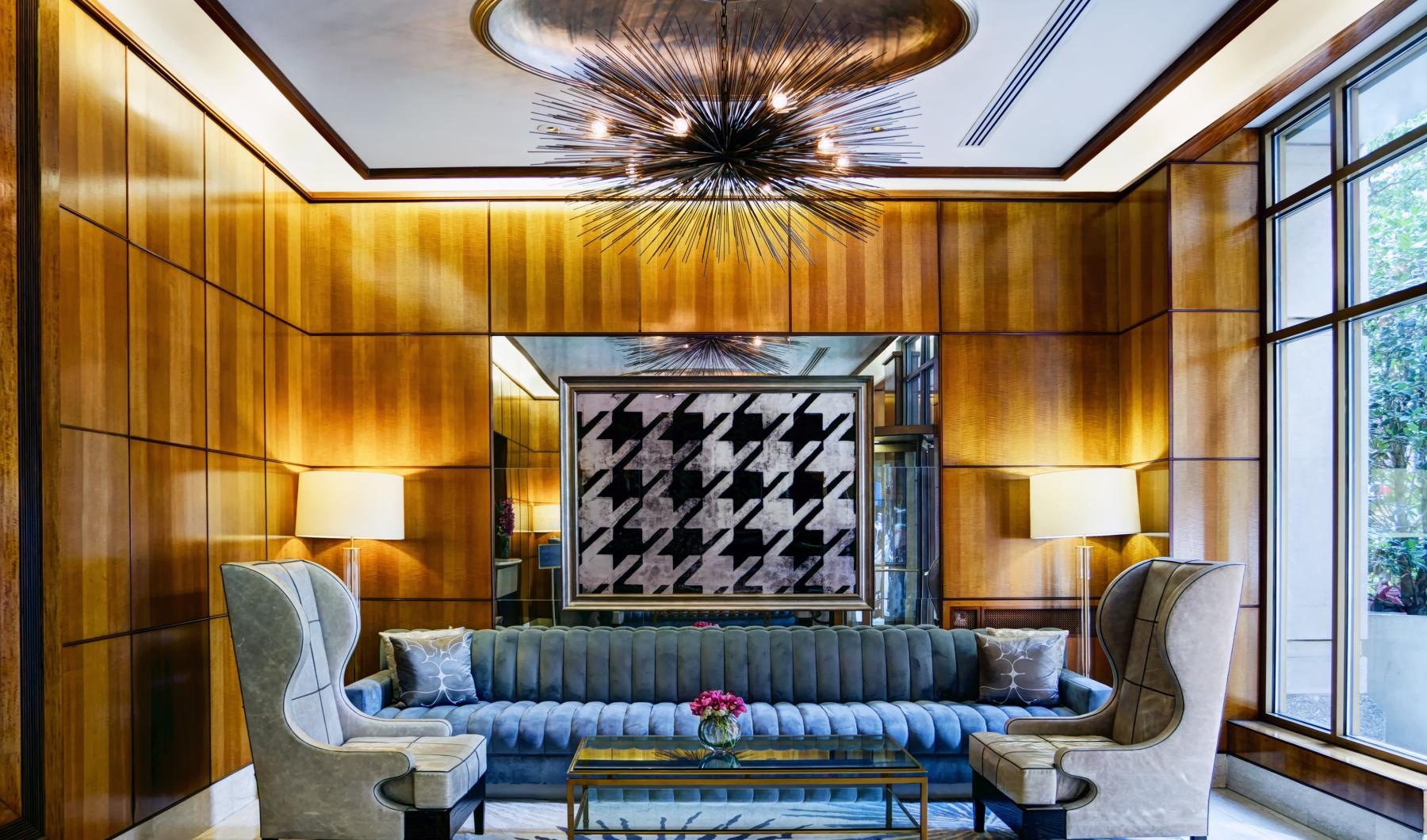 a clubhouse room with a large chandelier and a couch