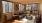 a living room with a large window, a couch, chair and a tv